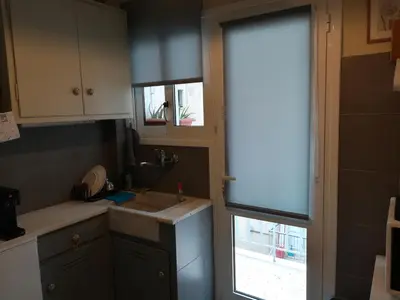 a kitchen with a sink and a window at Koukaki ideal studio for 2 in Athens
