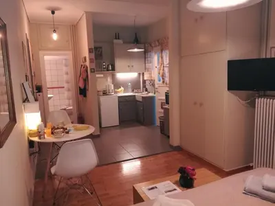 a kitchen and living room with a table and chairs at Koukaki ideal studio for 2 in Athens