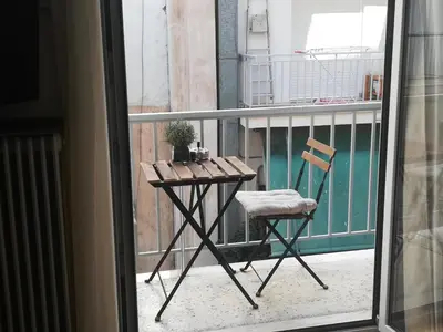 a table and a chair on a balcony at Koukaki ideal studio for 2 in Athens