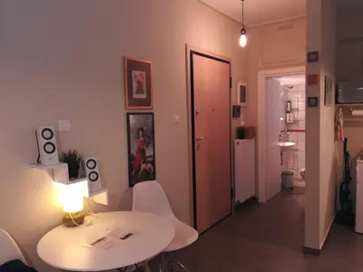 a room with a table and chairs and a hallway at Koukaki ideal studio for 2 in Athens