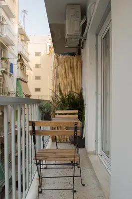 a balcony with a bench and a tv on a building at Koukaki ideal studio for 2 in Athens