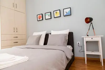 a bedroom with a bed with white walls at Gazi Discrit Next To Subway in Athens