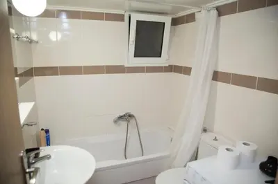 a bathroom with a sink and a tub and a toilet at Gazi Discrit Next To Subway in Athens