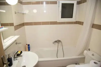 a bathroom with a white tub and a sink at Gazi Discrit Next To Subway in Athens