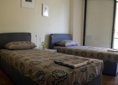 a room with two beds and a couch and a bed at ELITE apartment 5 min to Acropolis in Athens