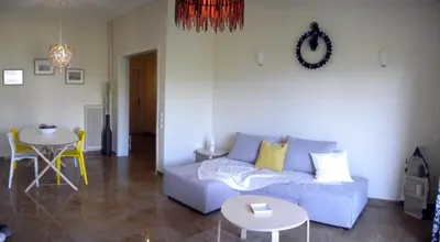 a living room with a couch and a table at ELITE apartment 5 min to Acropolis in Athens