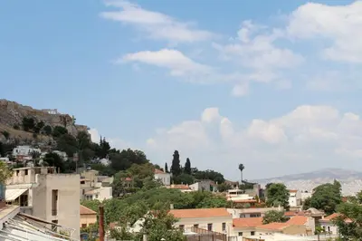 a town on a hill with houses and trees at Nefeli Hotel in Athens
