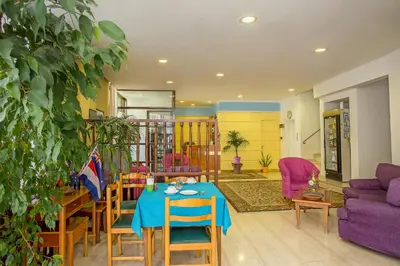 a living room with a table and a purple couch at Nefeli Hotel in Athens