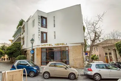 a group of cars parked in front of a building at Nefeli Hotel in Athens
