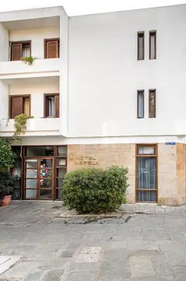 an external view of a white building with windows at Nefeli Hotel in Athens