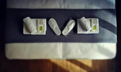 two pairs of shoes sitting on top of a bed at Dreamin Athens - Monastiraki Apartments in Athens
