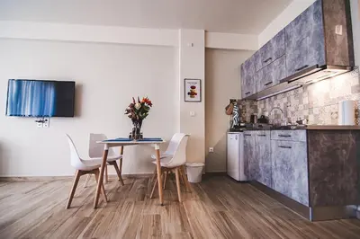 a kitchen and dining room with a table and chairs at Dreamin Athens - Monastiraki Apartments in Athens