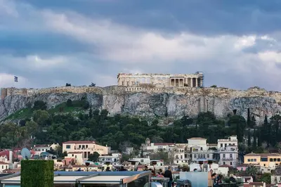 a building on top of a mountain with houses at Dreamin Athens - Monastiraki Apartments in Athens