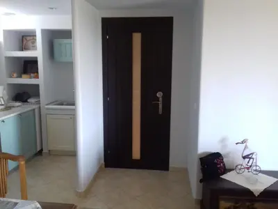 a black door in a room with a kitchen at Blue Sky appartment in Pallíni