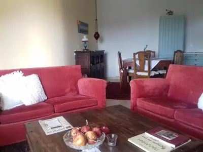 a living room with two red couches and a table at Blue Sky appartment in Pallíni