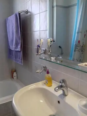 a bathroom with a sink and a mirror and a tub at Blue Sky appartment in Pallíni