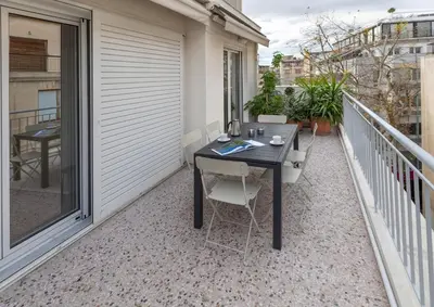 a small balcony with a table and chairs on it at Leonidas Loft in the heart of Athens by GHH in Athens