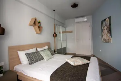 a bedroom with a large white bed in a room at Dynasta Central Suites in Athens