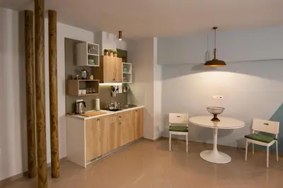 a kitchen with a table and a small table and chairs at Dynasta Central Suites in Athens