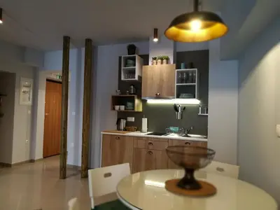 a kitchen with a table and a sink and a counter at Dynasta Central Suites in Athens