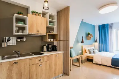a kitchen with a sink and a bed in a room at Dynasta Central Suites in Athens
