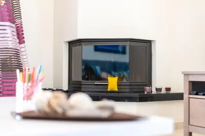 a living room with a tv and a plate of food at Leo - Unique Glyfada Apartment in Athens