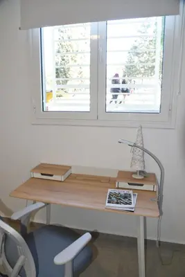 a desk in a room with a window at Acropolis At Your Door in Athens