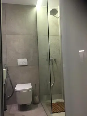 a bathroom with a toilet and a glass shower at Acropolis At Your Door in Athens