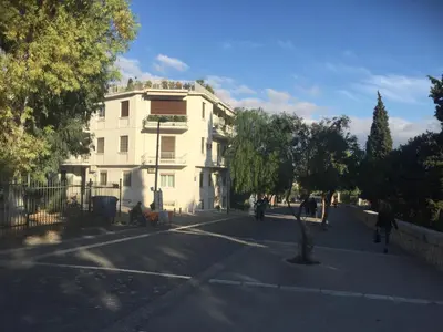 a white building on the side of a street at Acropolis At Your Door in Athens
