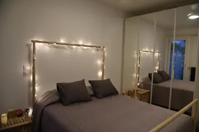 a bedroom with a bed and a large mirror at Acropolis At Your Door in Athens