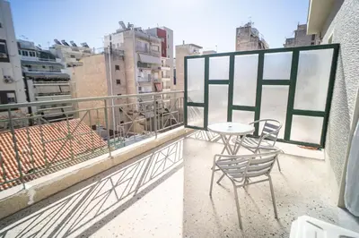 a balcony with a table and chairs on a balcony at Eva Hotel Piraeus in Piraeus