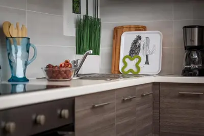a kitchen counter with a cutting board and a bowl of fruit at Absolute Athens II in Athens