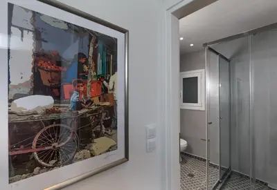 a painting on the wall in a room with a toilet at Absolute Athens II in Athens