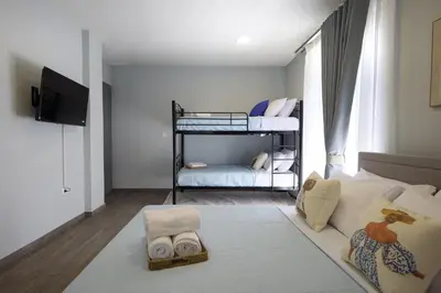 a bedroom with two bunk beds and a living room at Alpha Residence in Athens