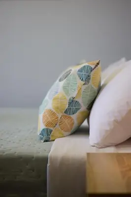 two pillows sitting on top of a bed at Alpha Residence in Athens
