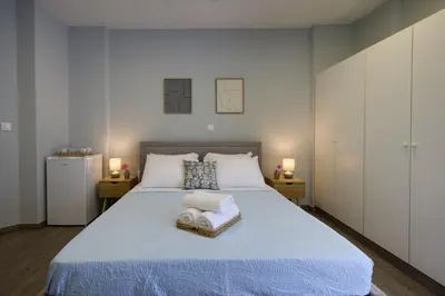 a bedroom with a large bed with two towels on it at Alpha Residence in Athens