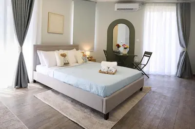 a bedroom with a large bed and a mirror at Alpha Residence in Athens