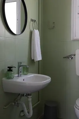 a bathroom with a sink and a mirror at Alpha Residence in Athens