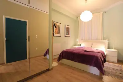 a bedroom with a bed and a glass door at Athens Plaka Modern Decorated Apartment in Athens