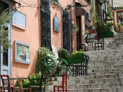 a table and chairs sitting on the steps of a building at Athens Plaka Modern Decorated Apartment in Athens