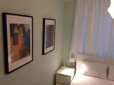 a bedroom with a bed and two pictures on the wall at Athens Plaka Modern Decorated Apartment in Athens
