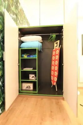 a closet with green shelves and a tie in it at Athens Plaka Modern Decorated Apartment in Athens