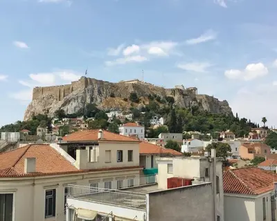 a view of a mountain from the roofs of houses at Athens Plaka Modern Decorated Apartment in Athens