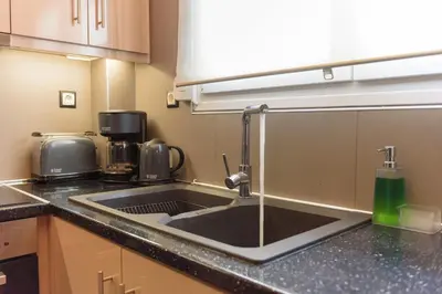 a kitchen with a sink and a coffee maker at Armoniko in Athens