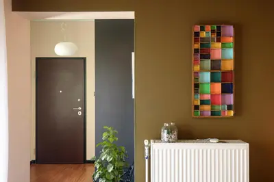 a hallway with a door and a painting on the wall at Armoniko in Athens