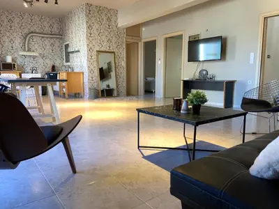 a living room with a couch and a table at Sepolia Apartment in Athens