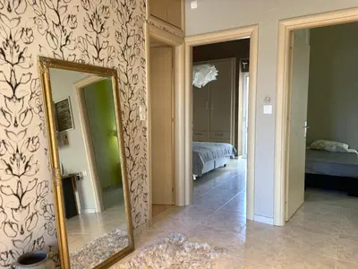 a mirror in a room with a bed and a bedroom at Sepolia Apartment in Athens