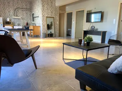 a living room with a couch and a table at Sepolia Apartment in Athens