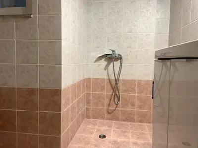 a shower with a shower head in a bathroom at Sepolia Apartment in Athens