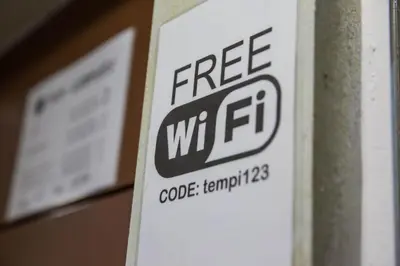 a sign that says free wifi on a wall at Tempi Hotel in Athens